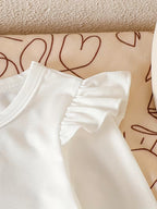 Pure White Long-sleeved Romper with Flutter Sleeves Paired with a Denim Floral Print