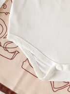 Pure White Long-sleeved Romper with Flutter Sleeves Paired with a Denim Floral Print